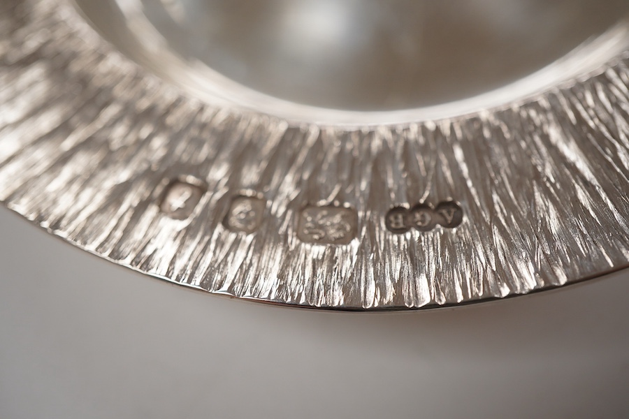 An Elizabeth II bark effect silver shallow bowl by Adrian Gerald Benney, London, 1974, top diameter 9cm, together with a similar shallow dish, by Adrian Gerald Benney, London, 1974, diameter 11.9cm, 8.8oz.